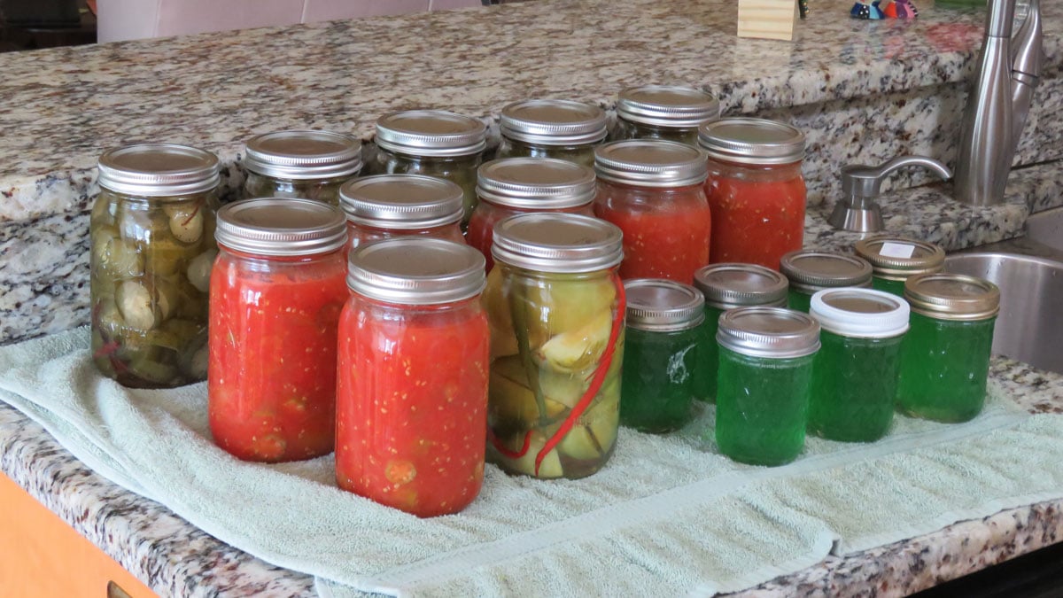 Photo of home-canned fruits and vegetables sitting on towel after a water bath