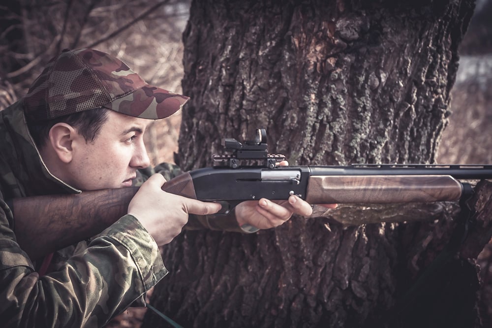 Hunter aiming for camouflage deer.jpg