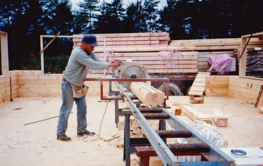 Building a log house with uncut logs